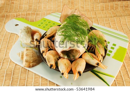 image of the dish with squid and boiled shrimp on a napkin from jute