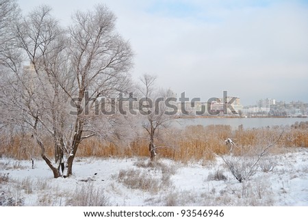 winter frozen lake on a background a city