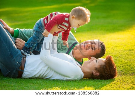 Happy family laying down in the garden