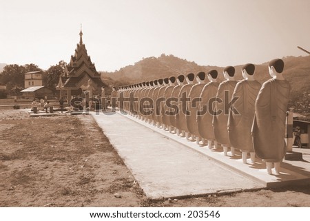 Statues of Monks lining up to pray to the Buddha
