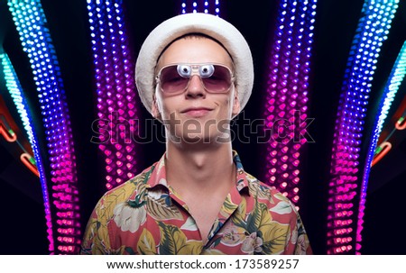 Beautiful young man on a beautiful background. Disco party. Good luck in card games on the big money.