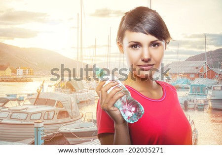 Beautiful girl with a bottle of water in hand. Taking part in sports. Healthy lifestyle. Healthy food