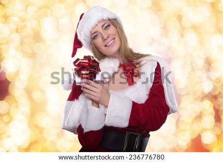 Beautiful young girl in a Christmas costume. New Year\'s holidays. Woman celebrating Christmas. Holiday gift