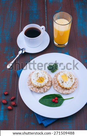 Fried eggs for breakfast. English breakfast. Morning coffee and juice. Wooden board rustic