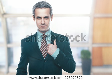 A handsome man in a jacket and tie for business negotiations. Looking at the camera. Office worker. Business decisions. Beautiful light background