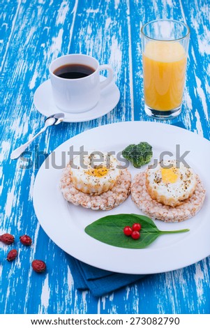 Fried eggs for breakfast. English breakfast. Morning coffee and juice. Wooden board rustic