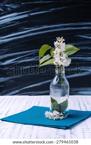 Gentle colored lilac in a vase. Spring flowers. Wooden board rustic