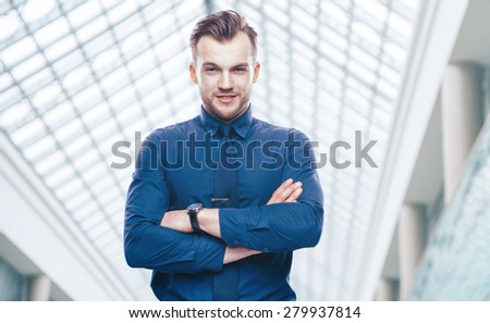 Handsome stylish young man in shirt looking at the camera. Office worker. Business decisions. Beautiful light background