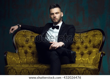 Handsome young man in a tuxedo looking at the camera. Fashionable Clothing. Clothing for the festive evening. Evening tuxedo. Fashion look