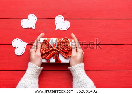 Gifts for Valentine\'s Day. Gift for a loved one. love story. Celebrating Valentine\'s Day. Festive gift. Lovers of the heart. Love. Insert text. Flat lay. Small gift in the hands of a woman