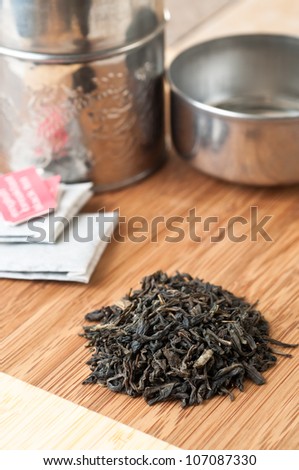 Exotic loose tea plus tea bags and container in vertical format