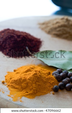 Grouping of five spices on wooden suface