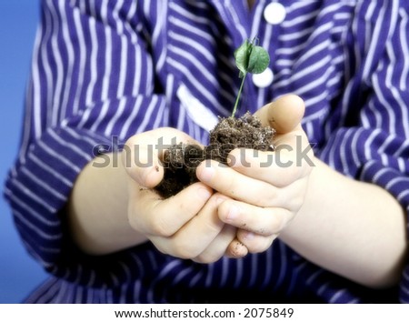 child with a little plant