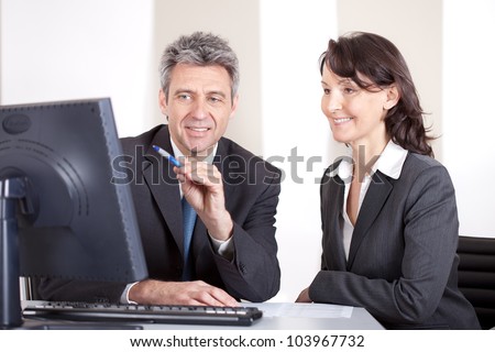 Two confident business people in the office at the meeting