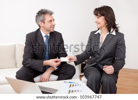 Two business people exchanging visiting card at the meeting