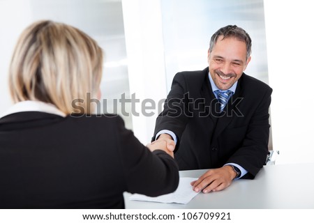 Portrait of successful businessman at the interview shaking hands