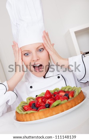 Beautiful chef woman making cake in the kitchen