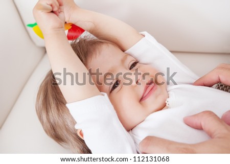 Portrait of a cute innocent young baby smiling and looking with enjoyment