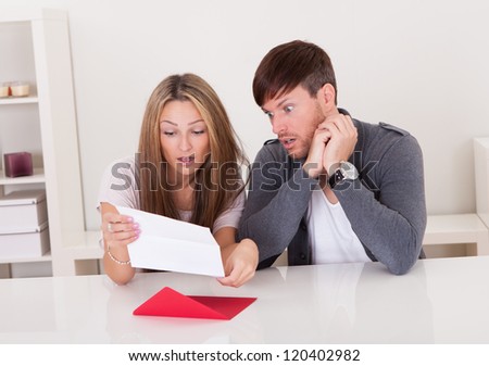 Shock portrayed on man\'s face after reading letter.