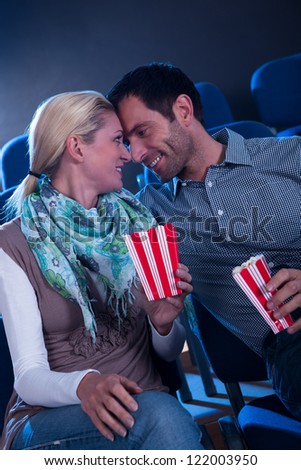 Stylish couple having romantic moment in a movie theater