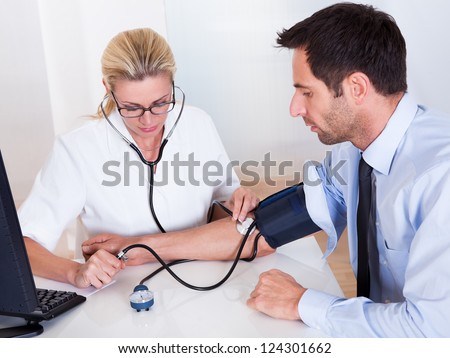 Young Female Doctor Or Nurse Taking Patients Stock Photo 