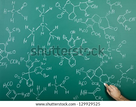 Organic chemical formulas on a green chalkboard