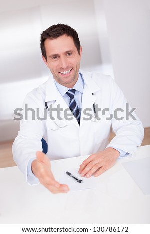 Portrait Of Happy Male Doctor Giving Hand For Handshaking
