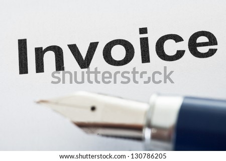 Close-up on invoice letters and pen tip