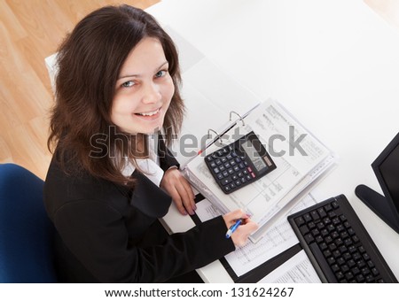 Portrait Of Happy Businesswoman Working In Office