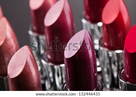 Lipsticks In A Row Isolated Over Gray Background