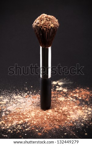 Makeup Brush And Cosmetic Powder Isolated On Black Background