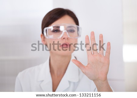 Portrait Of Female Scientist Touching The Screen With Her Finger