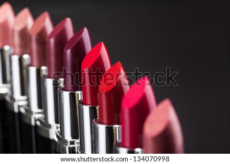 Lipsticks In A Row Isolated Over Gray Background
