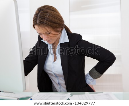 Business Woman With Back Pain Holding Her Aching Hip