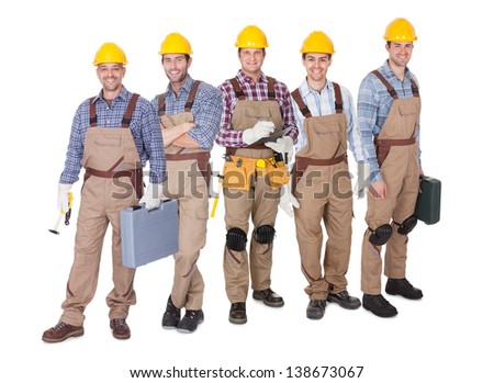Portrait of happy industrial workers team. Isolated on white