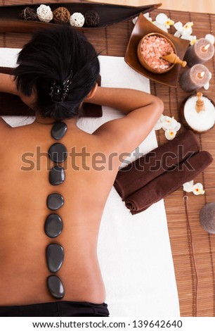 Young Woman Getting Spa Treatment With Stone Massage