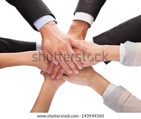 Close-Up Of Businesspeople Hands Stacking Together Over White Background
