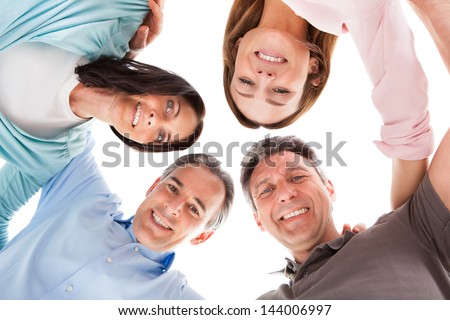 Group Of Happy People Making Huddle Over White Background