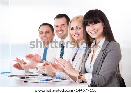 Happy Business People Clapping In The Office