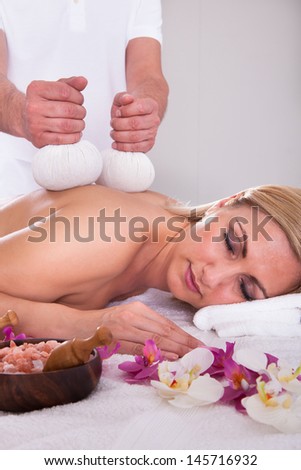 Beautiful Young Woman Getting Herbal Therapy At Spa Salon
