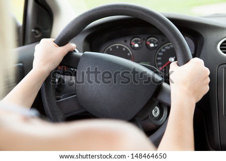 Close-up Of Woman\'s Hand Holding Steering Wheel