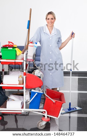 Young Happy Maid Cleaning The Floor With Mop
