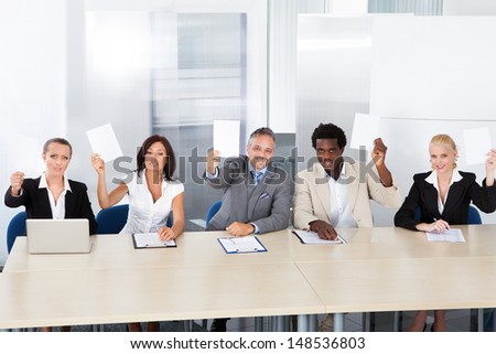 Group Of Happy Corporate Personnel Officers Holding Blank Paper