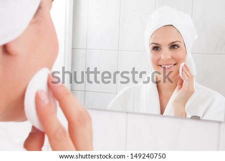 Young Woman Wiping Face With A Cotton