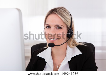 Portrait Of Happy Young woman Operator With headset