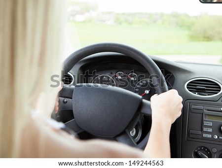 Close-up Of Woman\'s Hand Holding Steering Wheel