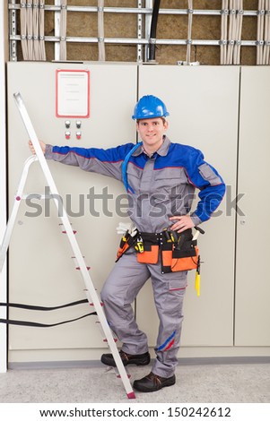 Young Worker Man With Hard Hat Leaning On Ladder