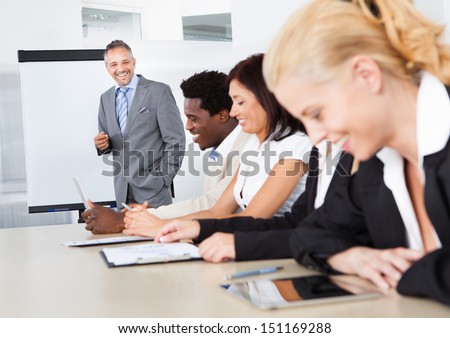 Businesspeople Sitting In Office At The Presentation
