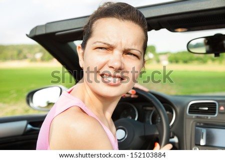 Young Woman Looking Back While Travelling In Car