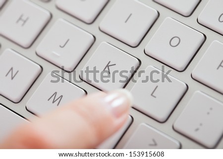 Close-up Of Female Finger Pressing Key On Keyboard